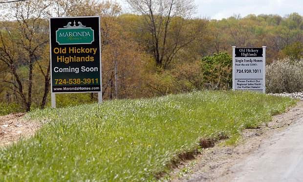In this Monday, May 6, 2013 photo, construction is underway on the infrastructure of a multi-acre housing development in Zelienople, Pa. The Commerce Department reports on new-home sales for May, on Tuesday, June 25, 2013. (AP Photo/Keith Srakocic)