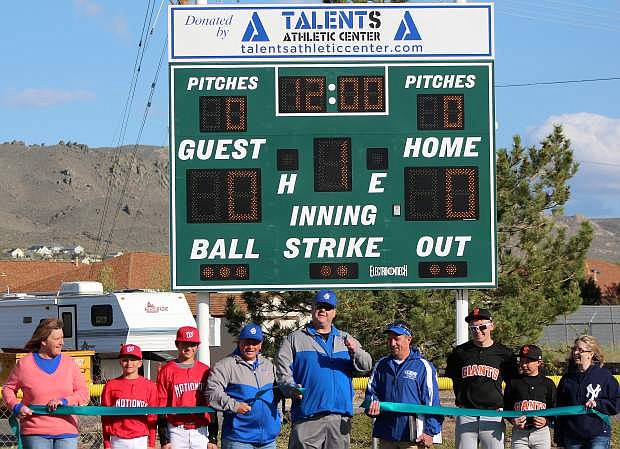 Rob Heaton, owner of Talent Athletics Center, donated a new scoreboard to Carson City Little League and Carson City Pop Warner. Shown at the ribbon cutting and dedication ceremony are Carson City Little League President Tom Lawson, center, and Carson City Pop Warner President Brett Clampitt, center right.