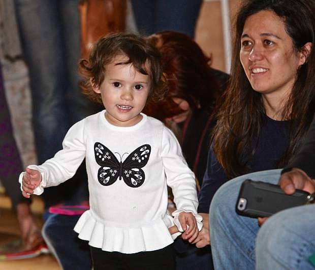 2 1/2-year -old Brooke Malloy dances to the drum beats while her mother Rachel looks on Saturday at the Children&#039;s Museum.