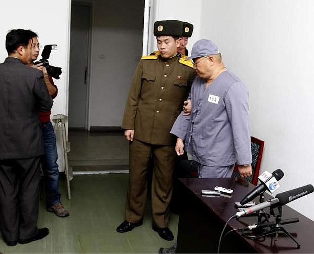 American missionary Kenneth Bae, right, leaves after speaking to reporters at Pyongyang Friendship Hospital in Pyongyang Monday, Jan. 20, 2014. Bae, 45, who has been jailed in North Korea for more than a year, appealed for the U.S. to do its best to secure his release. (AP Photo/Kim Kwang Hyon)