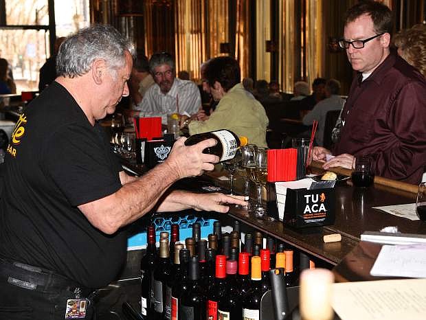 Alatte bartender Giovanni Melia pours wine for RGJ media&#039;s Robert Glenn Friday evening at the Carson Nugget during the unveiling party.