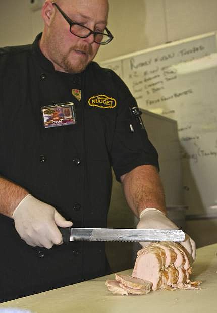 Carson Nugget Executive Chef David Sellars hand-carves a portion of the 1800-2000 pounds of turkey to be served on Thanksgiving day in the Nugget kitchen Wednesday.