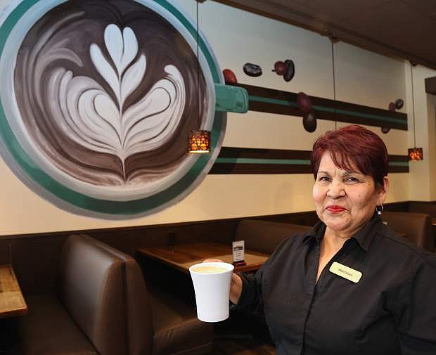 Located in the Carson Nugget, Alatte Coffe, Wine &amp; Deli barista Mercedes Jessmer serves a hot drink to a customer on Monday.