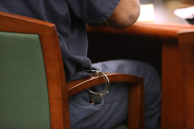 O.J. Simpson is handcuffed to the chair during a hearing at Clark County Regional Justice Center in Las Vegas, Monday, May 13, 2013. Simpson, who is currently serving a nine-to-33-year sentence in state prison as a result of his October 2008 conviction on armed robbery and kidnapping charges, is seeking a new trial, claiming that trial lawyer Yale Galanter had conflicted interests and shouldn&#039;t have handled Simpson&#039;s armed case. (AP Photo/Las Vegas Review-Journal, Jeff Scheid, Pool)
