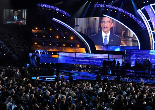 President Barack Obama appears on screen at the 15th annual Latin Grammy Awards at the MGM Grand Garden Arena on Thursday, Nov. 20, 2014, in Las Vegas. Obama unveiled his expansive executive actions on immigration Thursday night to spare nearly 5 million people in the U.S. illegally from deportation. (Photo by Chris Pizzello/Invision/AP)
