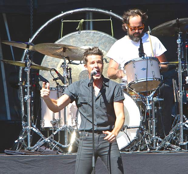 Lead singer Brandon Flowers and drummer Ronnie Vannucci, Jr. of the rock band The Killers perform for the crowd at the conclusion of the Lake Tahoe Summit Wednesday at Harvey&#039;s Outdoor Amphitheater.