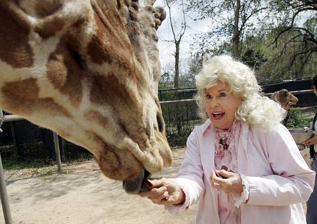FILE - In this March 4, 2009 file photo, Donna Douglas, who starred in the television series &quot;The Beverly Hillbillies&quot; tours the Audubon Zoo in New Orleans. Douglas, who played the buxom tomboy Elly May Clampett on the hit 1960s sitcom has died. Douglas, who was 82, died Thursday, Jan. 1, 2015, in Baton Rouge, where she lived, her niece, Charlene Smith, said.  (AP Photo/Bill Haber, File)