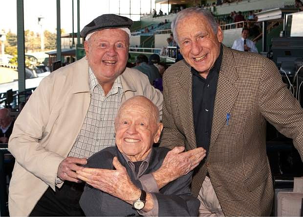 FILE - In this Sunday, March 30, 2014, file photo, entertainment icons Dick Van Patten, left, and Mel Brooks flank Mickey Rooney at Santa Anita Park, in Arcadia Calif. Rooney, a Hollywood legend whose career spanned more than 80 years, has died. He was 93. Los Angeles Police Commander Andrew Smith said that Rooney was with his family when he died Sunday, April 6, 2014, at his North Hollywood home. (AP Photo/Benoit Photo, File)