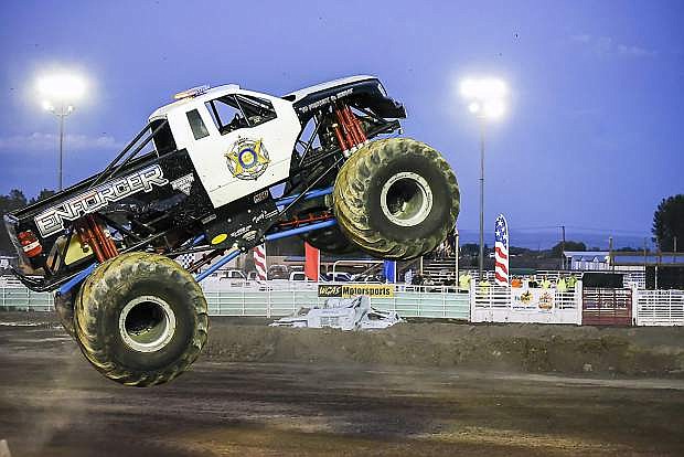 The Enforcer hits a highway divider turned on its side like a ramp and bounces into the air with its police lights rolling at Octane Fest on Saturday.