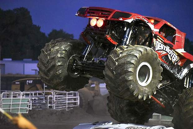 The Destroyer hits a sideways car ramp and flies through the air, showing off its underside and high-beam red headlights at Saturday&#039;s Octane Fest event at Churchill Fairgrounds.