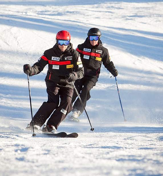 Dr. Jonathan Finnoff, left, and Dr. Terrence Orr ski down a mountain.