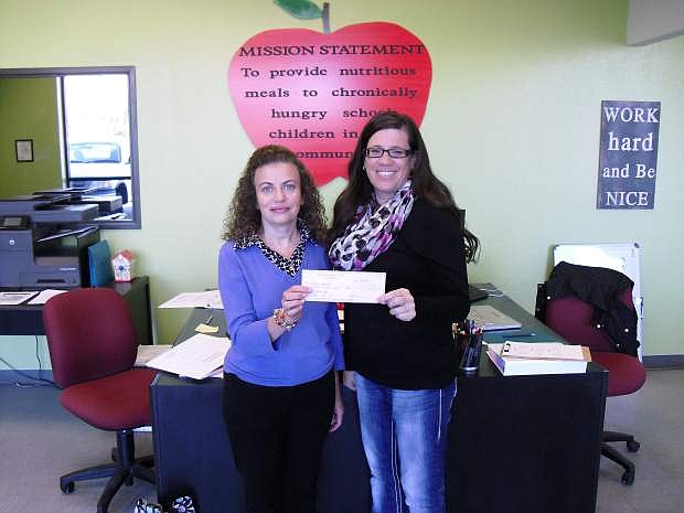 Monica Marcinko, media chair for Professional Saleswomen of Nevada, presents a $198 check to Marlene Maffei, executive director of Food For Thought.