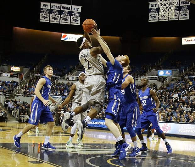 Nevada&#039;s Tyron Criswell jumps to the hoop against Air Force&#039;s Frank Toohey.