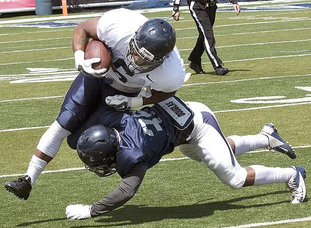 Nevada&#039;s Jarid Joseph tackles Don Jackson in the first half of the Silver and Blue game.