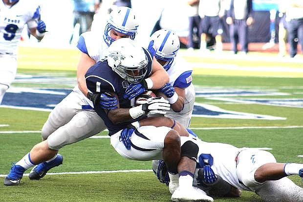 Nevada wide receiver Brandon Wimberly is tackled by a pair of Air Force defenders during a game this year. The Wolf Pack will play at Notre Dame in 2016.