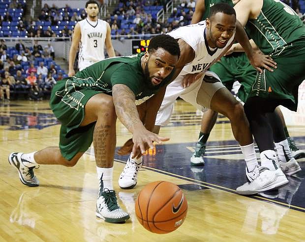 Nevada&#039;s D.J. Fenner battles with Colorado State&#039;s Stanton Kidd for a loose ball in a game from the 2014-15 season.