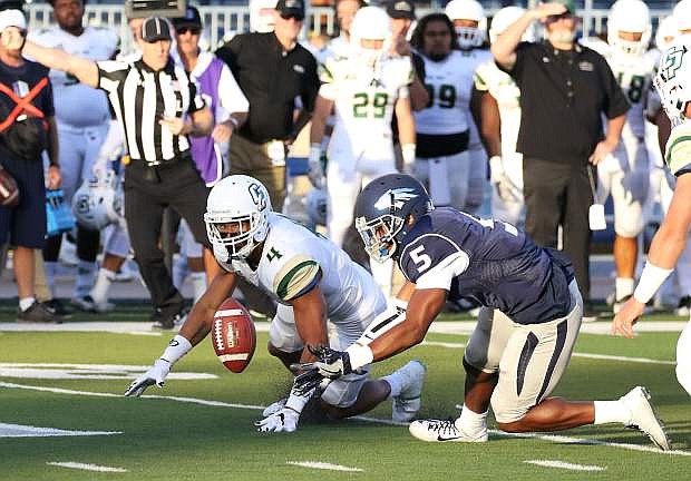 Nevada&#039;s Dameon Baber and Cal Poly&#039;s Kyle Lewis battle for the fumble in the first quarter of Friday&#039;s opener at Mackay Stadium.
