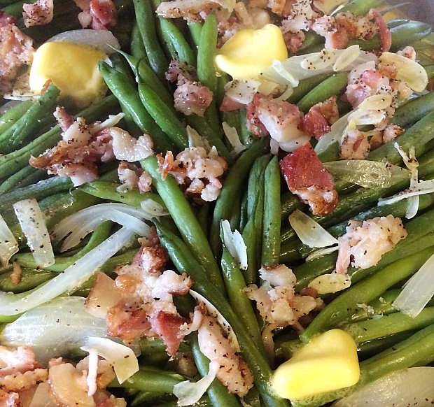 Dress up French green beans with the addition of garlic, onion and bacon.
