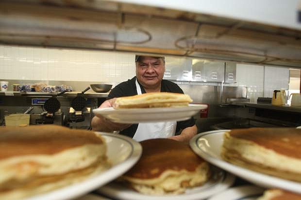 IHOP cook Rafael Montano was busy making pancakes for customers during National Pancake Day on Tuesday.