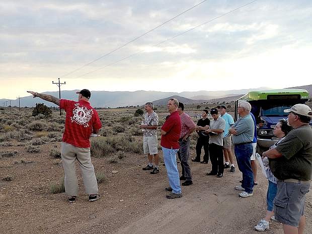 Skot Meyer, Reno Disc Golf Association president, with a sweeping gesture points out topographical and other features at one of Carson City&#039;s prospective sites for the sport during a bus tour meeting of the Parks and Recreation Commission.
