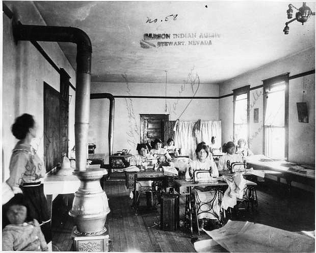 Students at Stewart Indian School Leaning sewing in about 1900.