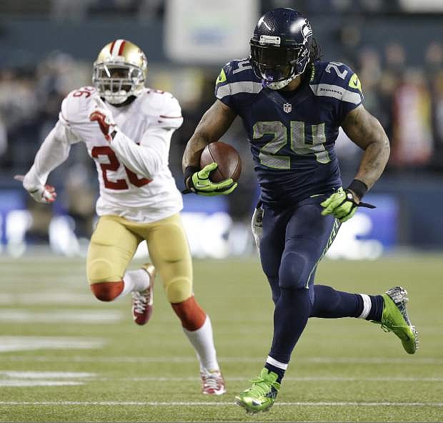 Seattle Seahawks&#039; Marshawn Lynch breaks away for a touchdown run during the second half of the NFL football NFC Championship game against the San Francisco 49ers Sunday, Jan. 19, 2014, in Seattle. (AP Photo/Elaine Thompson)