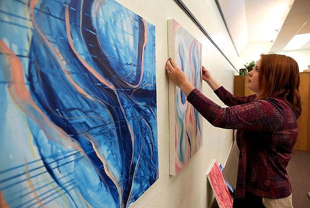Artist Julianne Perkins hangs her &quot;Breaking Free&quot; exhibit at the Carson City Library. Her show will be open to the public during business hours through Aug. 15.