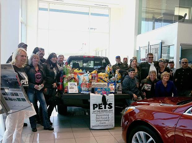 Twenty-eight motorcycles and a chase car from Cowboy &amp; Company filled their saddle bags with dog and cat food and donated 350 pounds of pet food for Pets of the Homeless on Oct. 12.