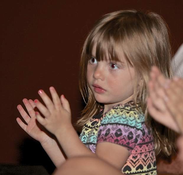 3-year-old Julianna Jackson claps for the Pioneer graduating class Wednesday evening.