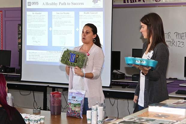 UNR/Orvis School of Nursing students Melissa McPherson and Amy Allen give a presentation on proper nutrition to Pioneer High School students Thursday.
