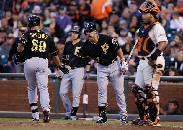 Pittsburgh Pirates&#039; Tony Sanchez (59), left, celebrates his solo home run with teammate Andrew Lambo during the fifth inning of a baseball game against the San Francisco Giants on Saturday, Aug. 24, 2013, in San Francisco. (AP Photo/Marcio Jose Sanchez)