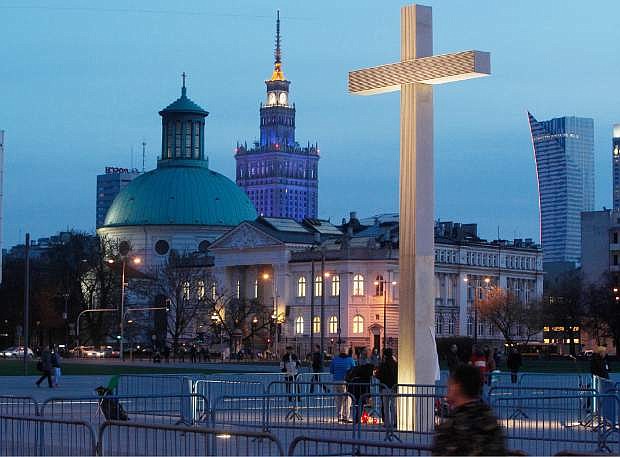 FILE - In this April 2, 20014 file photo an unusually empty main square with a commemorative cross in downtown Warsaw, Poland on Wednesday, April 2, 20014 during observances marking nine years since the death of much-loved Polish-born Pope John Paul II. Over the years, the observances attract fewer and fewer people in an a sign that the enthusiasm that the Poles accord one of their greatest countrymen is gradually dissipating.(AP Photo/Czarek Sokolowski, File)