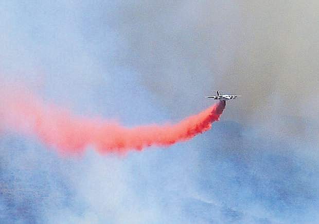 A large fire tanker makes a pass over the Minnehaha fire north of Topaz Ranch Estates on Saturday.