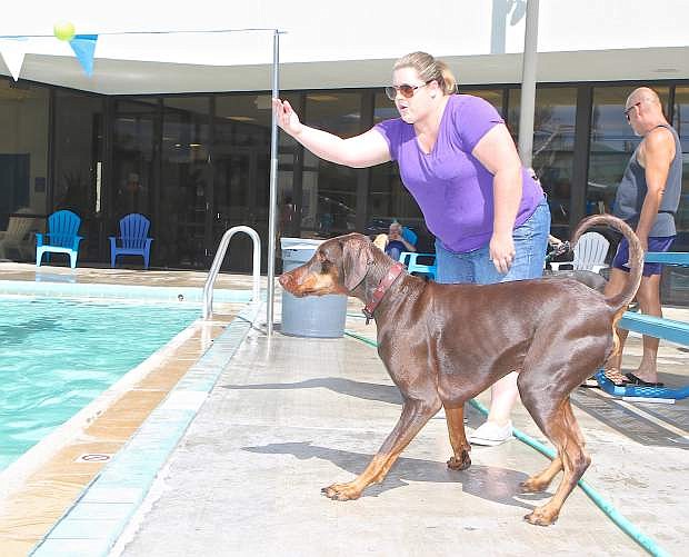 Myra Yeargan of Washoe Valley throws a tennis ball into the pool for her Doberman &#039;Red&#039; Saturday in Carson City.