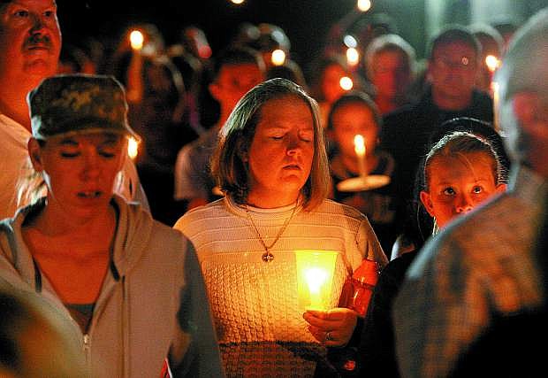 Community members gather for a candlelight vigil for the IHOP shooting victims on Sept. 6, 2011.