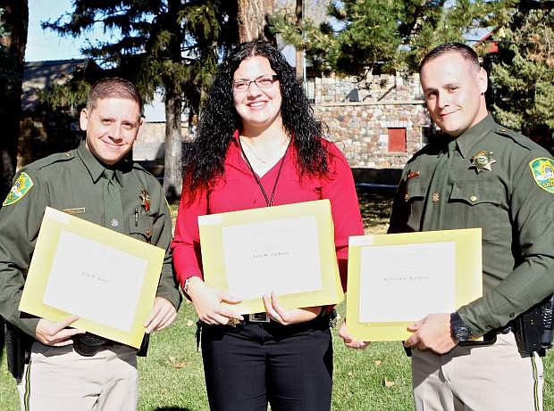 Erin M. Jackson of Carson City Juvenile Probation Services is flanked by CCSO graduates Arik M. Sitton (left) and Nicholas G. Simpson (right) Thursday at POST graduation ceremonies at the Stewart facility.