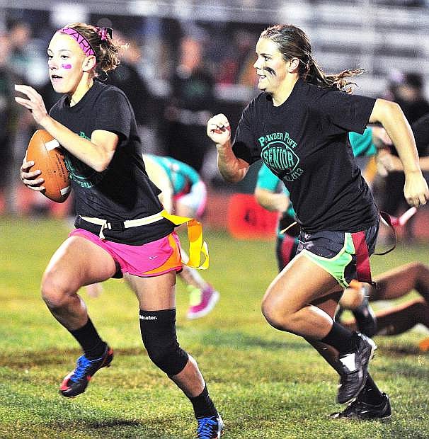 Churchill County High School senior Elena Murray, left, runs with the ball as teammate Mary Scholz looks to block during Monday&#039;s Powder Puff game at the Edward Arciniega Complex. The seniors beat the juniors, 38-21.