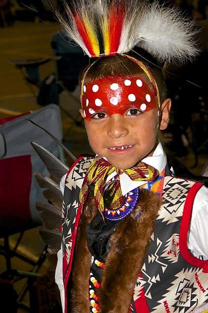 7-year-old Randy Garcia stops for a photo after his grand entrance dance at the La Ka Lel Be Pow Wow Friday night in Carson City.