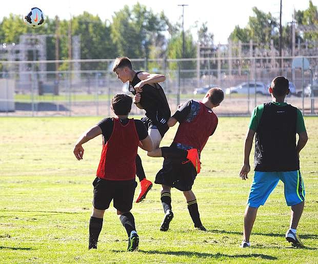 Fallon senior Tristan Parrott, in air, heads the ball on goal during a light practice on Thursday at Churchill County High School. Official practices for all fall sports began on Thursday.
