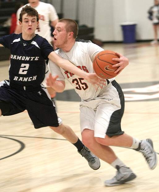 Douglas guard Trey Maurer drives to the basket past a Damonte Ranch defender on Tuesday night.