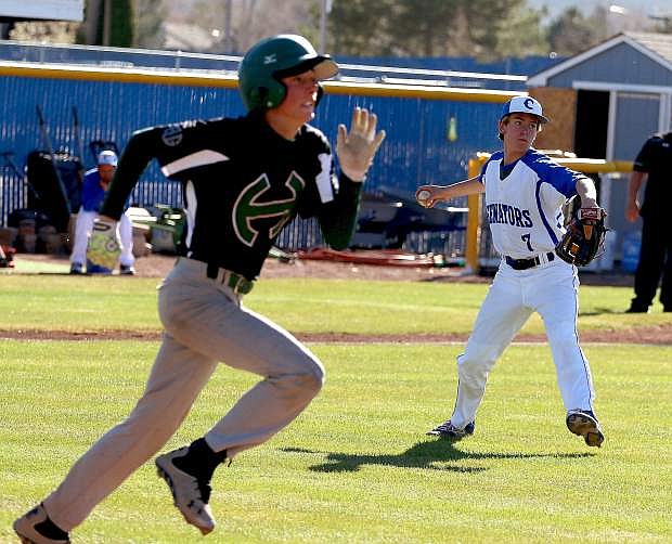 Carson High pitcher Jared Barnard throws to first to get the out after a bunt attempt by a Hug batter on Thursday at Carson High School.