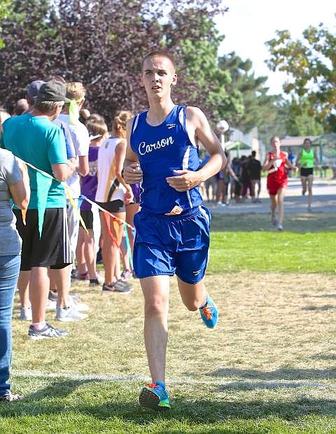 Logan Meade is the first male finisher in the senior event for Carson High at Lampe Park Friday during the cross country class races hosted by Douglas High.