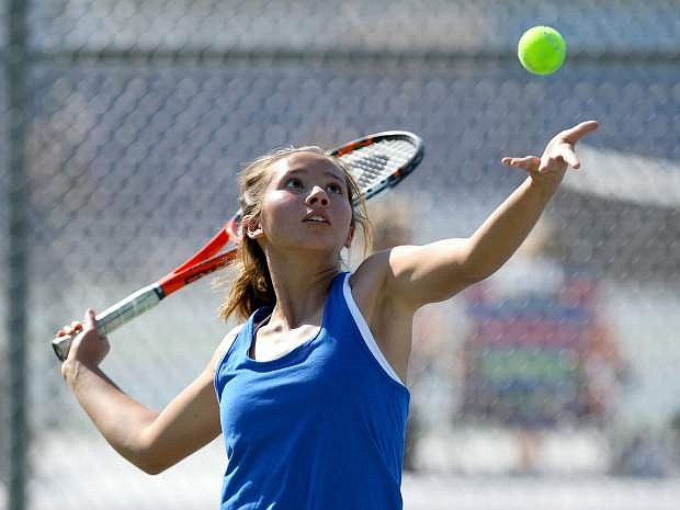 Singles player Anya Woodbury serves in a match against Douglas on Tuesday.