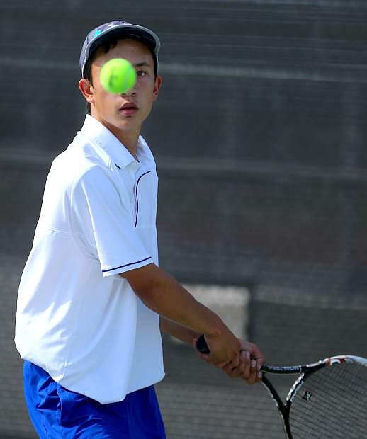 Singles player Ryan Tomita sets up for a return volley in a match against McQueen on Tuesday.