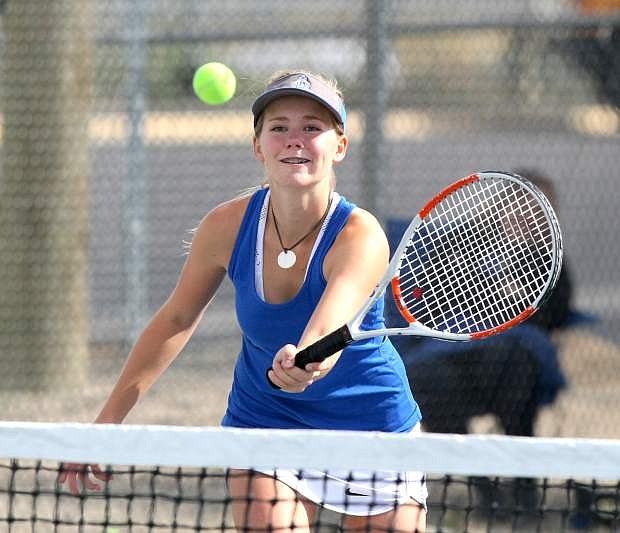 Doubles player Elise Brady charges the net for a return in a match against Reed on Tuesday.