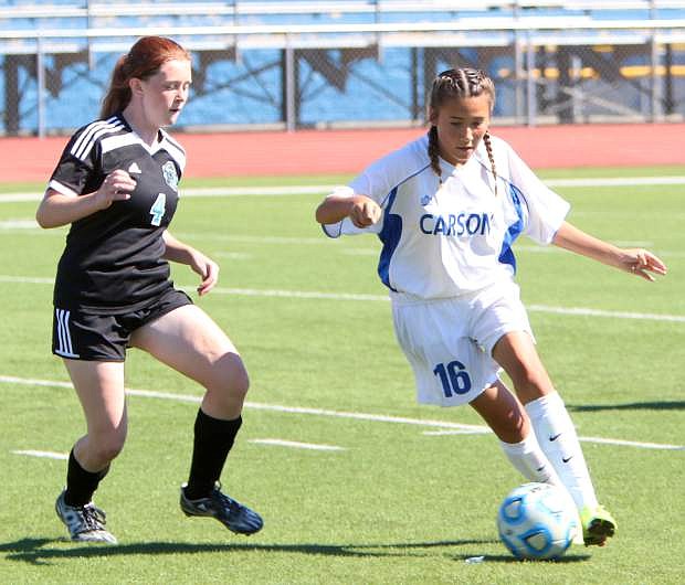 Mia Olmos pushes upfield in the first periond agains North Valleys for the Carson JV girls Saturday afternoon.