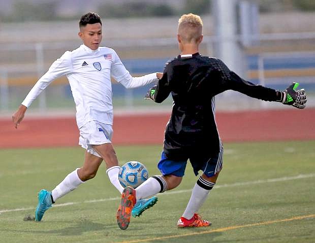 Senator junior Osvaldo Gomez shoots the ball behind the McQueen goalie for Carson&#039;s first score Wednesday night at the Jim Frank Track and Field Complex.