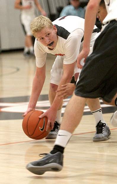 Dylan Pfaffenberger of Douglas gains control of a loose ball in a game against McQueen on Tuesday night.