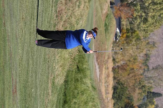 Heather Evans eyes her approach shot onto the 11th green at Rosewood Lakes Golf Course on Tuesday.
