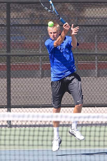 Junior Taylor Saarem, Carson High Tennis Team&#039;s no.1 seed, volleys with his Spanish Springs opponent Thursday afternoon at CHS.